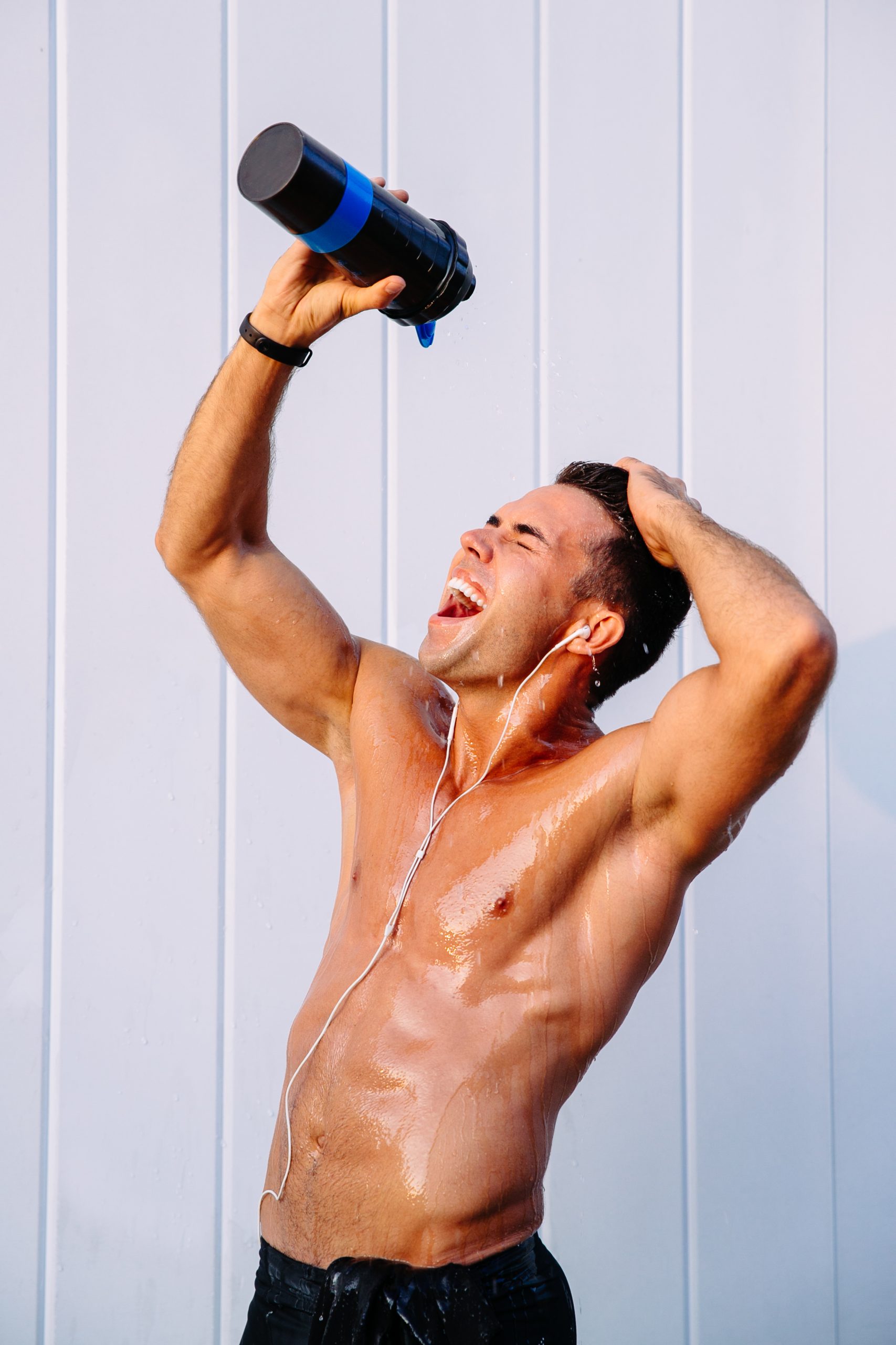 Unveiling Men's Intimate Hygiene: Addressing Unique Needs Navigating Hygiene Differences and Tips for Active Lifestyles 1 happy muscular guy pouring out water from bottle his body sweating after training scaled - Unveiling Men's Intimate Hygiene: Addressing Unique Needs Navigating Hygiene Differences and Tips for Active Lifestyles
